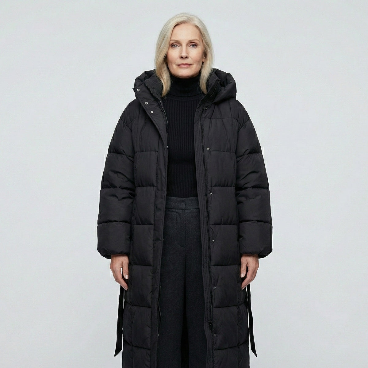 Women's longline puffer coat with a hood and tie belt - black