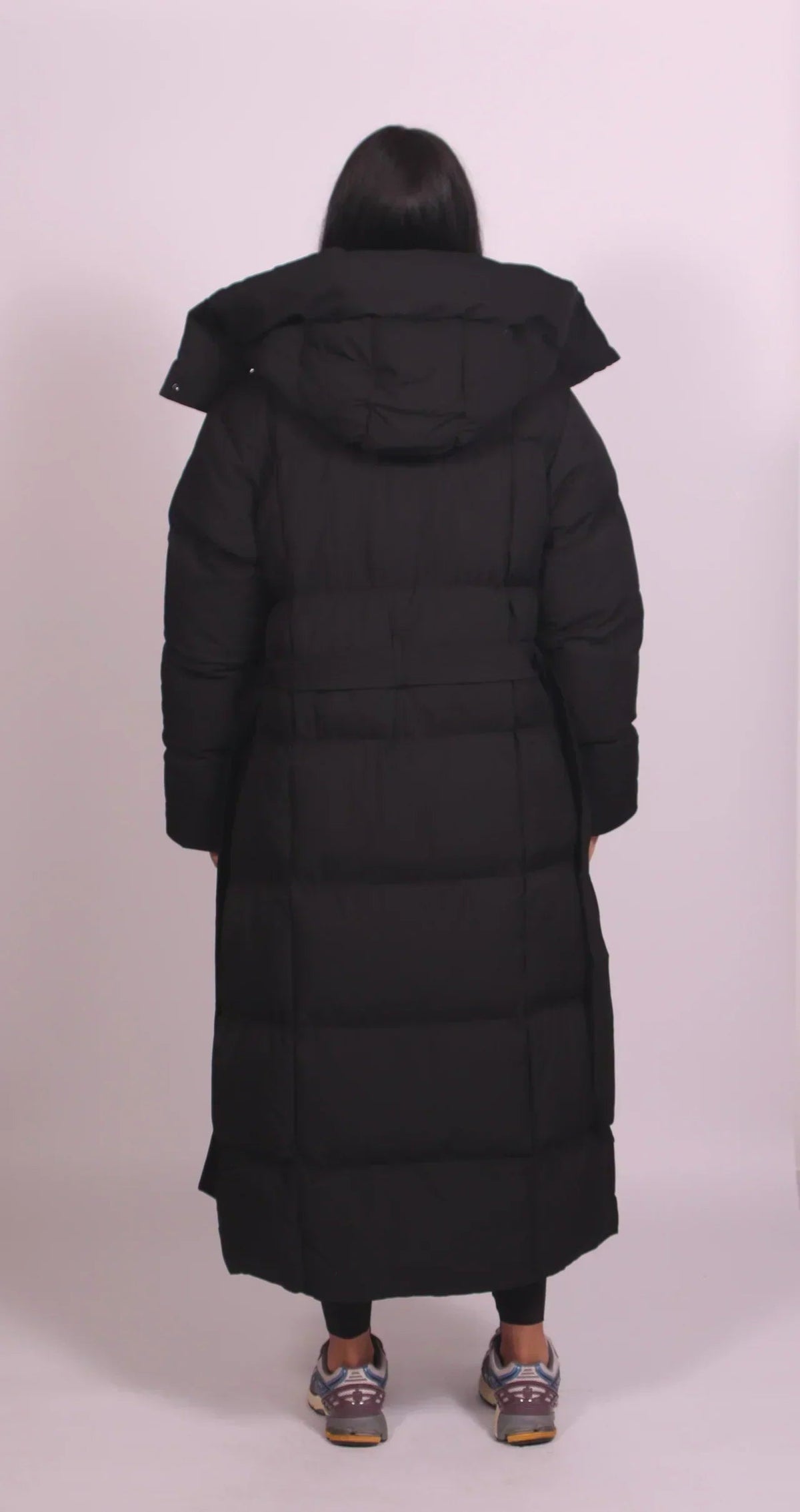 Women's longline puffer coat with a hood and tie belt - black
