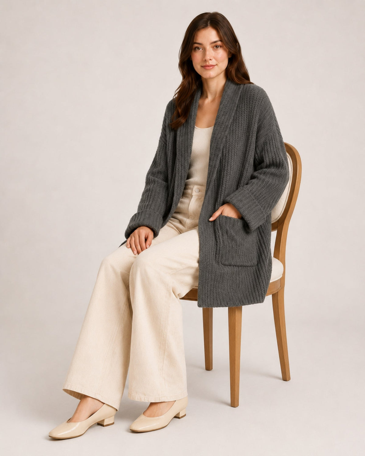 Women's longline ribbed cardigan with a shawl collar and patch pockets
