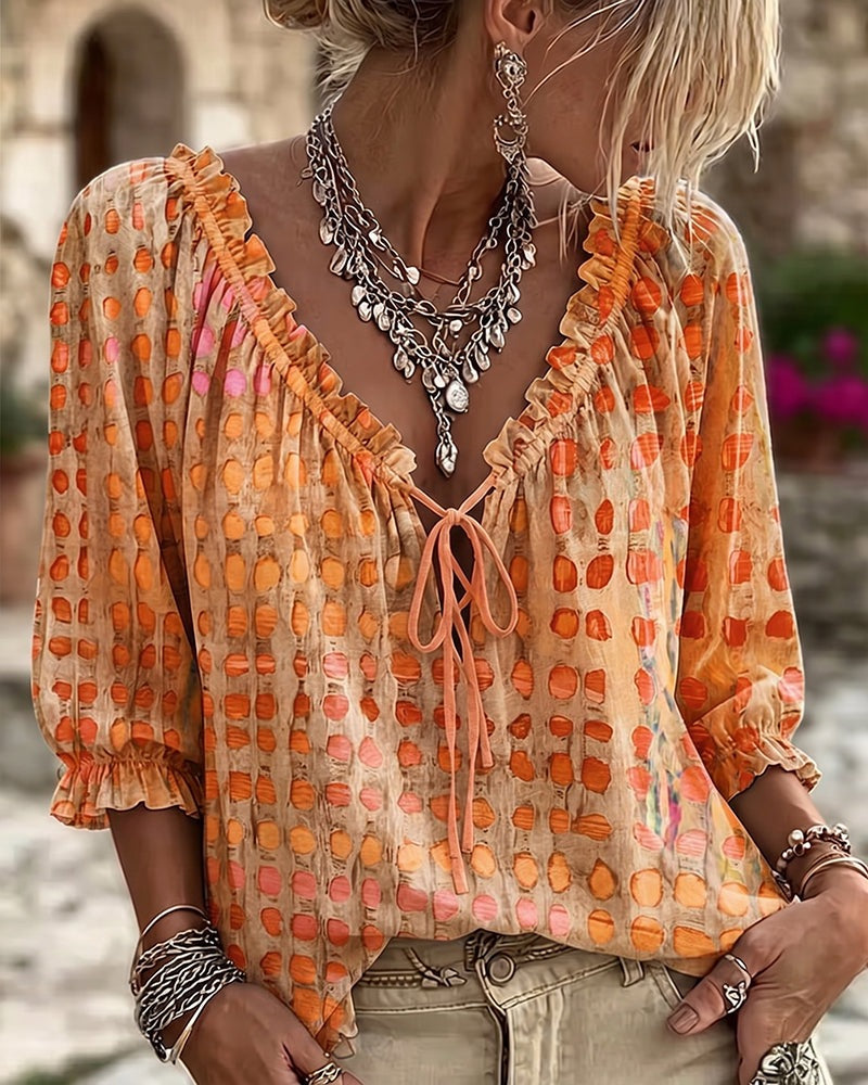 Loose polka dot blouse with a ruffled V-neck and tie cord - orange