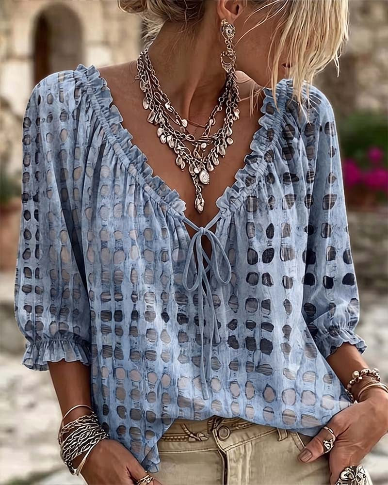 Loose polka dot blouse with a ruffled V-neck and tie cord - light blue
