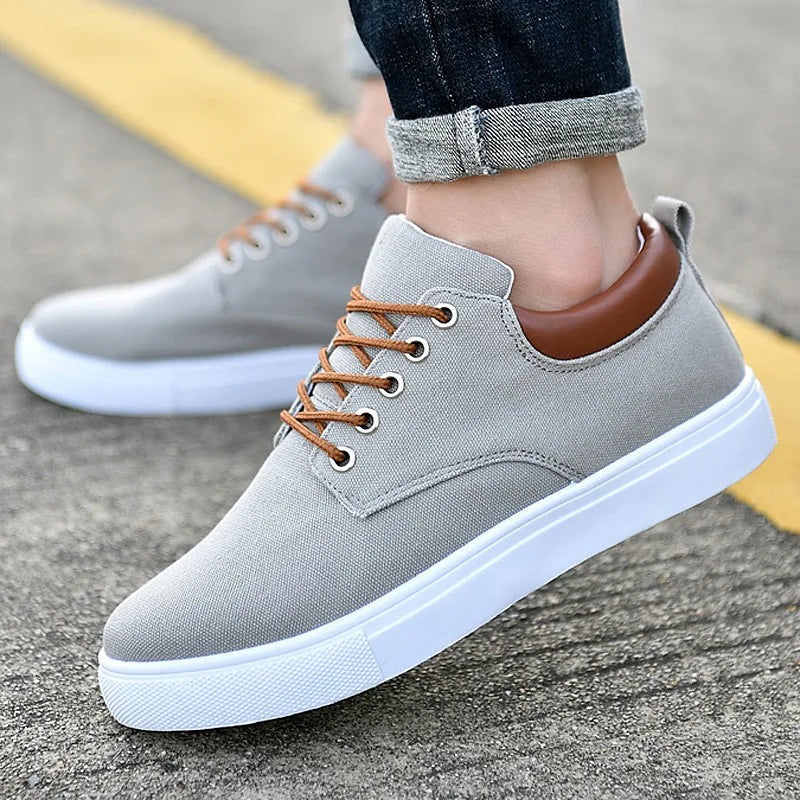 Men's canvas trainers with a white rubber sole, tan laces and a faux leather heel piece - light grey