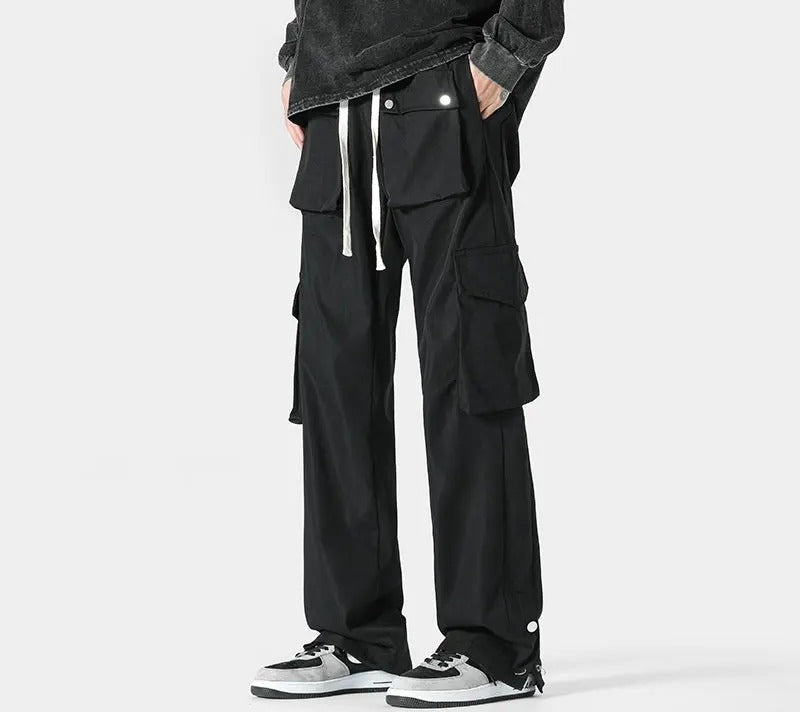 Men's cargo trousers with flap pockets at the waist and thighs, a drawcord and popper hems - view 3