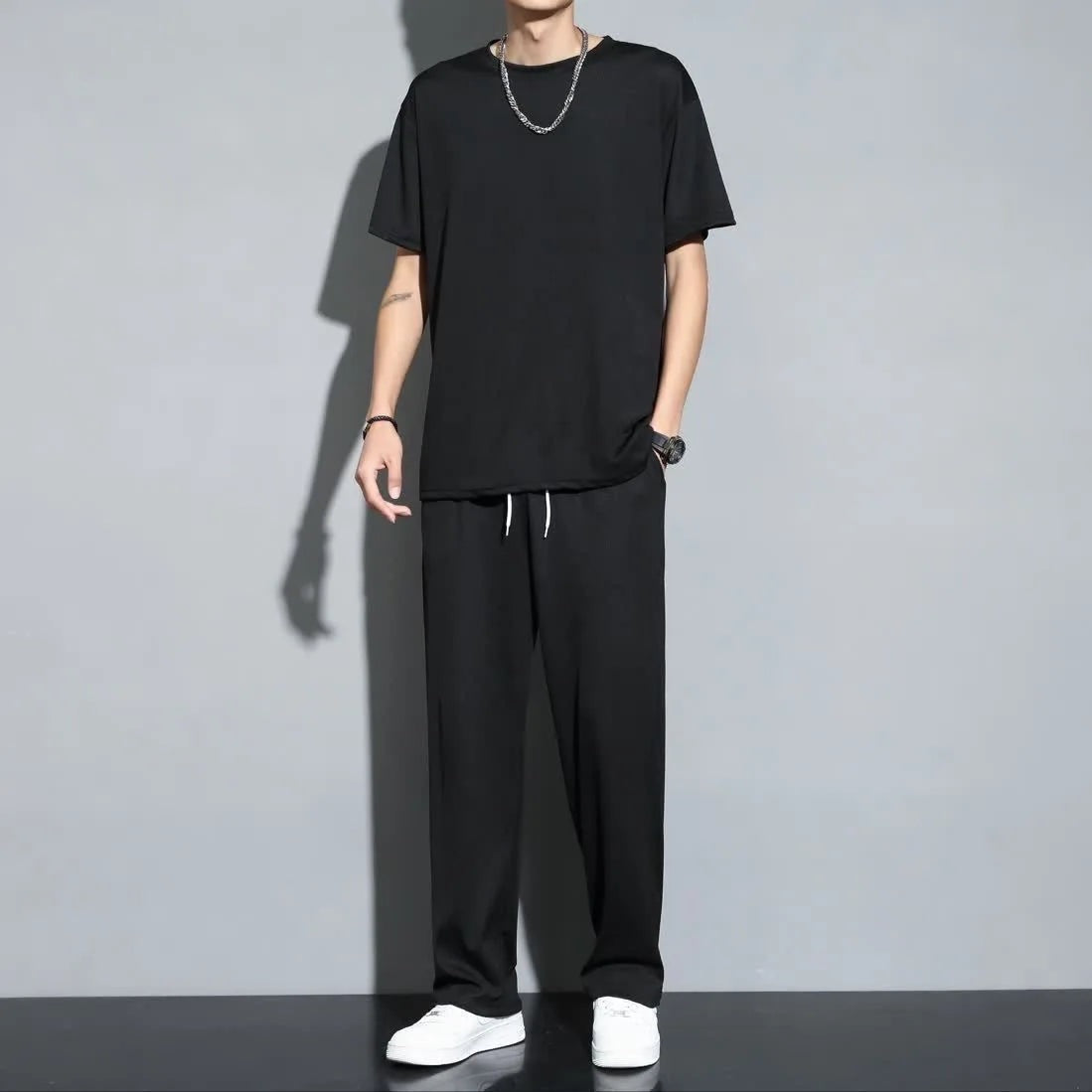 Men's two-piece set with a crew-neck T-shirt and straight trousers in a smooth cool-touch fabric - black