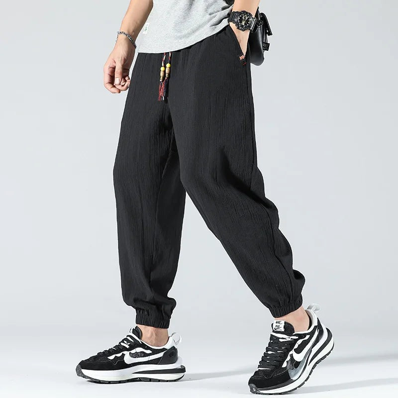 Men's lightweight cotton linen trousers with elasticated cuffs and a beaded drawcord - black