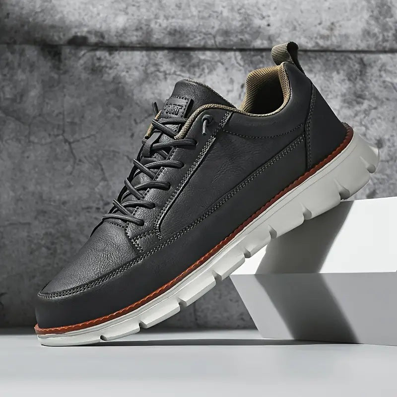 Men's smooth faux leather trainers with a flexible grooved sole and tan welt - charcoal