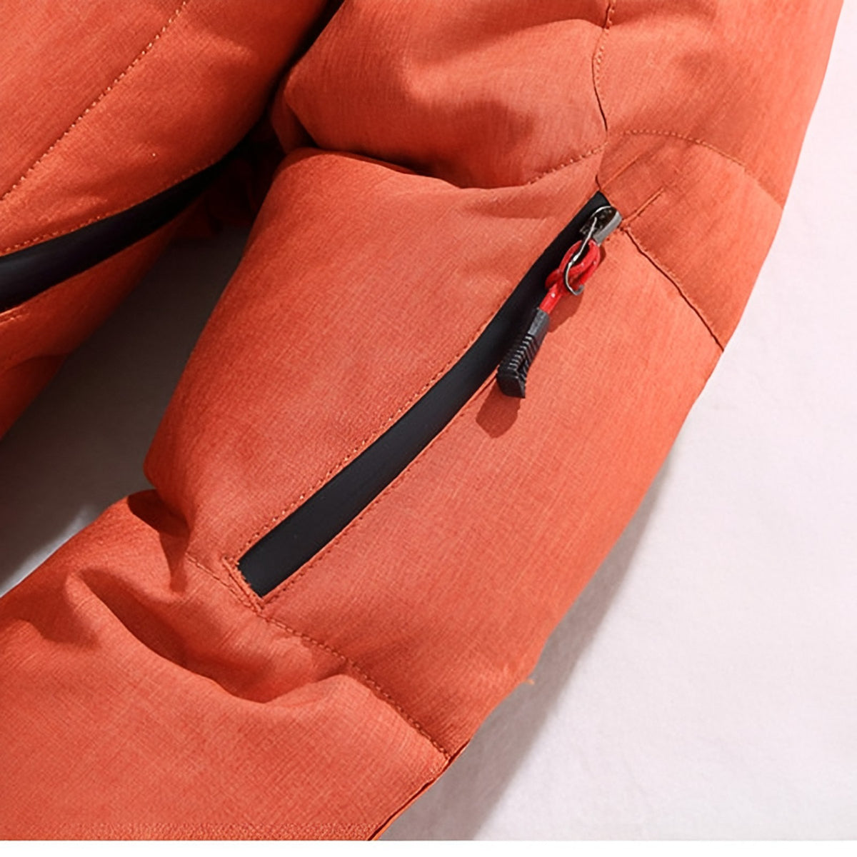Men's hooded puffer jacket with wide quilted panels, zipped chest pockets and adjustable cuffs