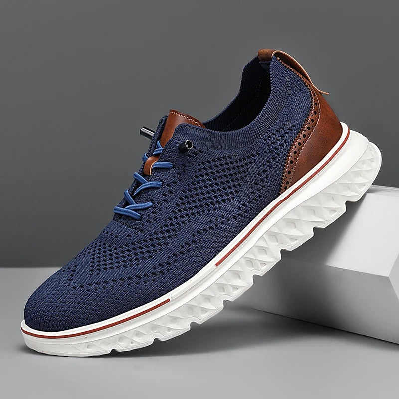 Men's knit mesh trainers with a faux leather heel, red trim along the sole and elastic laces - navy
