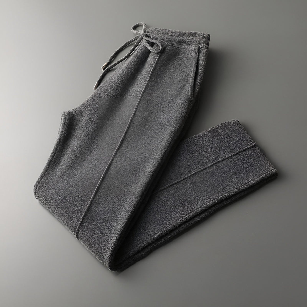 Men's knitted wool trousers in dark grey, folded with drawstring waist