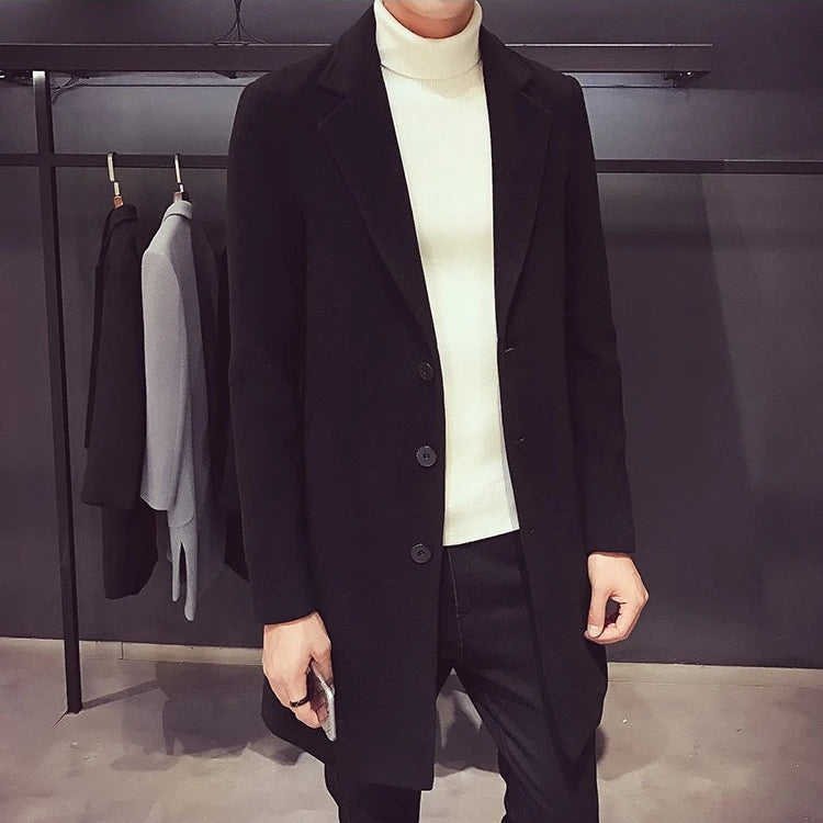 Men's black longline coat worn open, front
