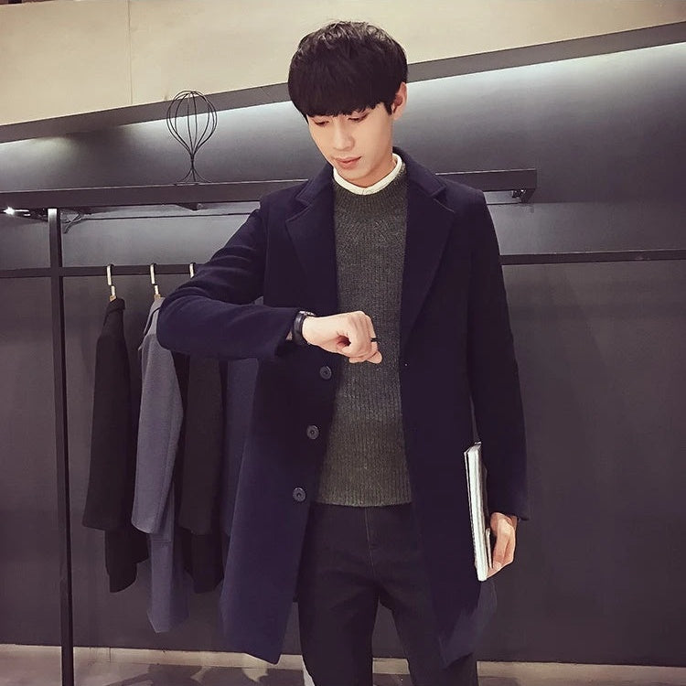 Men's navy longline coat, model checking his watch