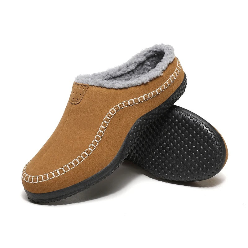 Men's mule slippers in a suede look with teddy lining and whipstitch trim along the sole