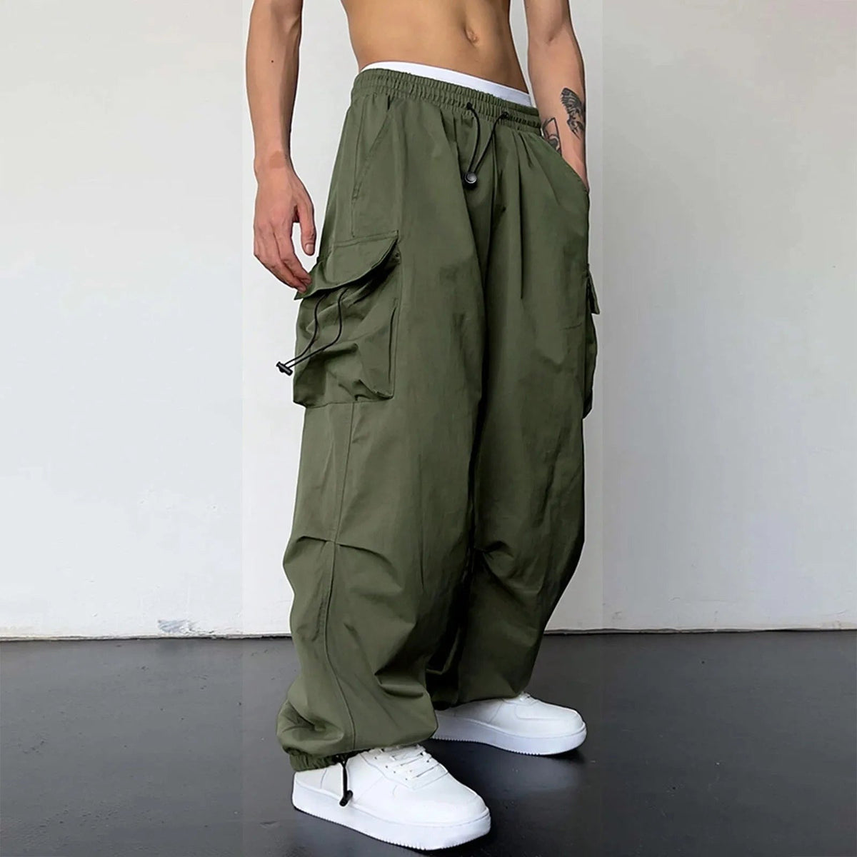 Men's wide-leg cargo trousers with a drawcord waist, flap pockets and adjustable ankles - army green