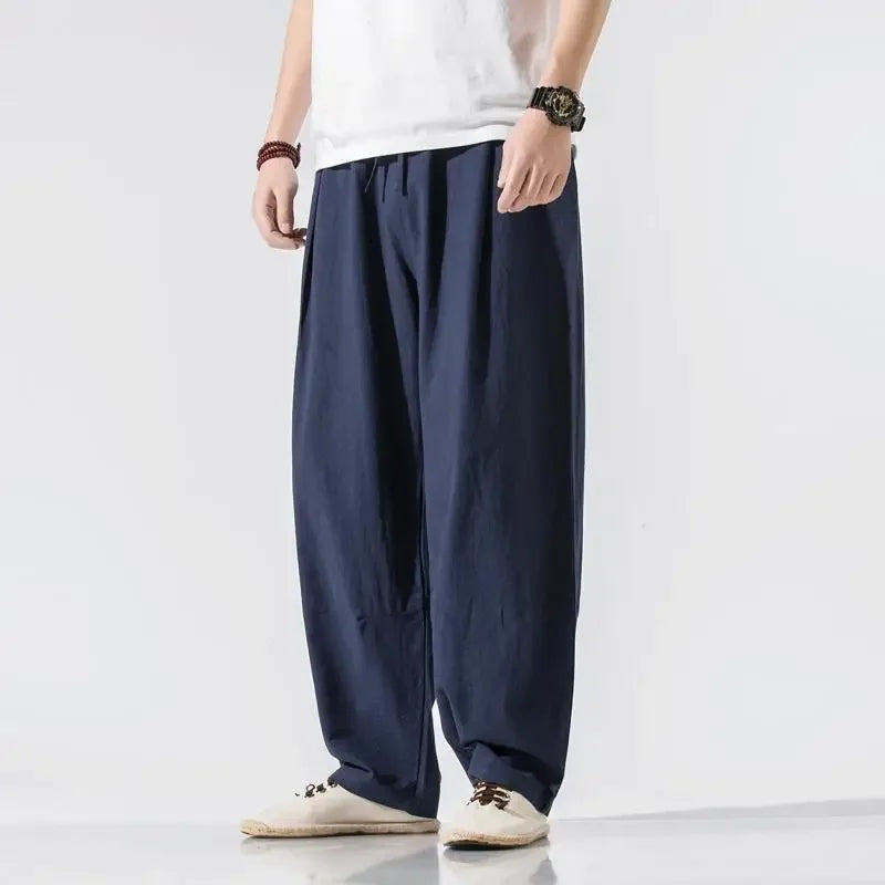 Men's wide-leg linen blend trousers with an elasticated drawstring waist and pleats - navy