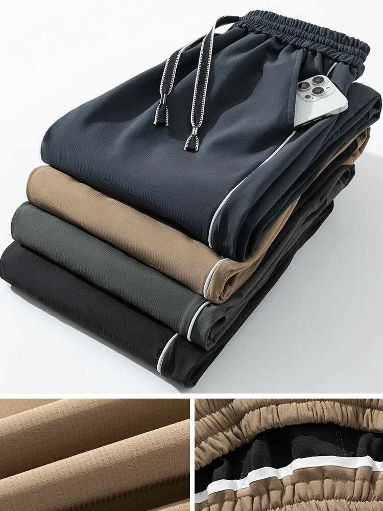 Men's wide-leg track trousers with white piping, a contrast panel on the lower leg and popper hems - view 2