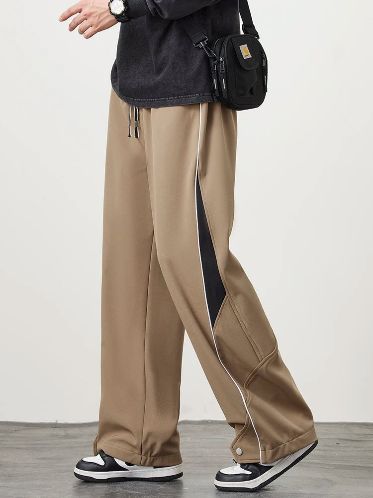Men's wide-leg track trousers with white piping, a contrast panel on the lower leg and popper hems - camel