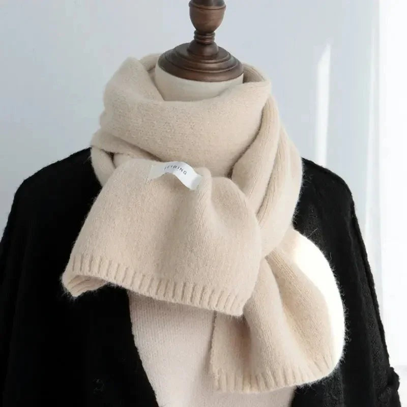 Women's narrow knitted scarf with ribbed ends and a small white label
