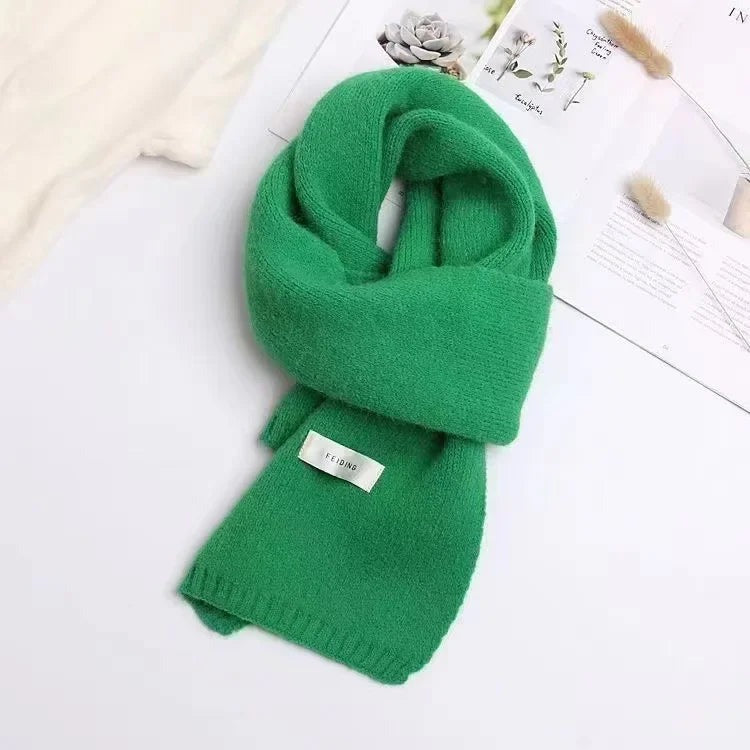 Women's narrow knitted scarf with ribbed ends and a small white label - green