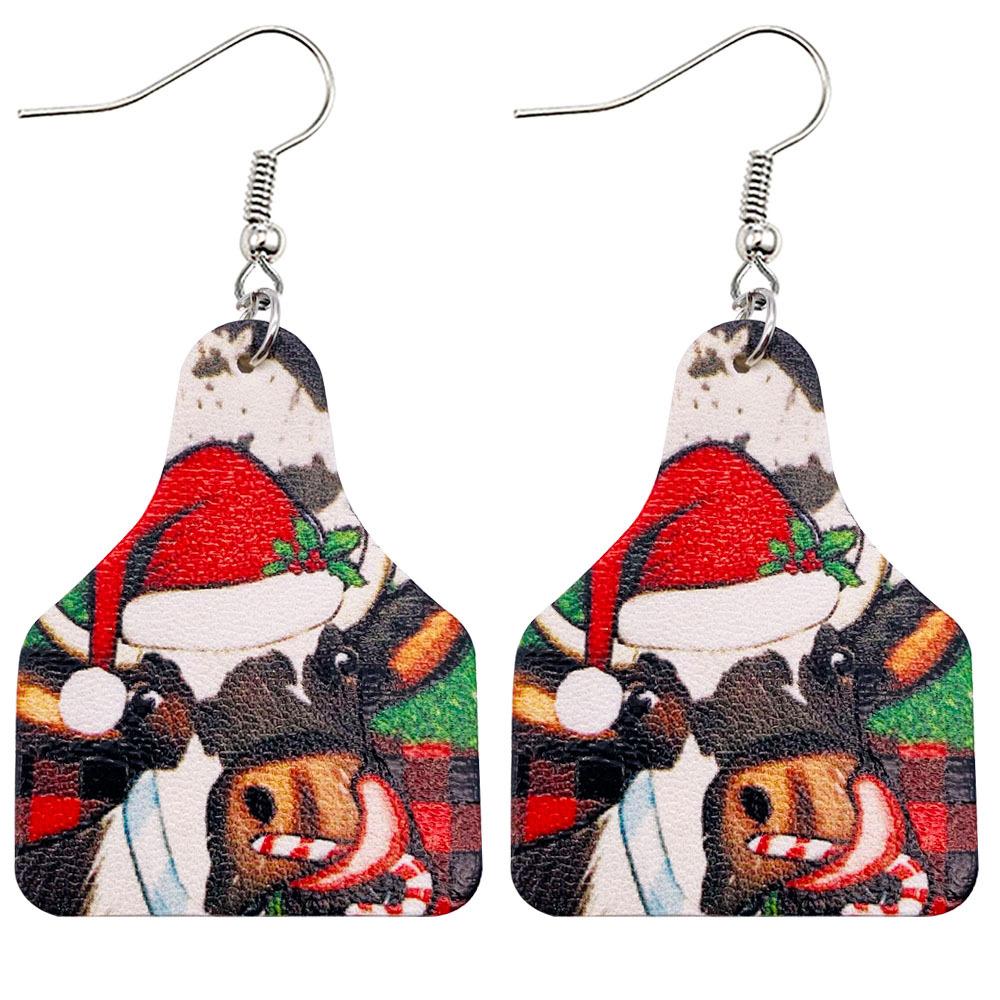 Faux leather Christmas drop earrings with a festive print on silver-tone hooks - black cow in santa hat