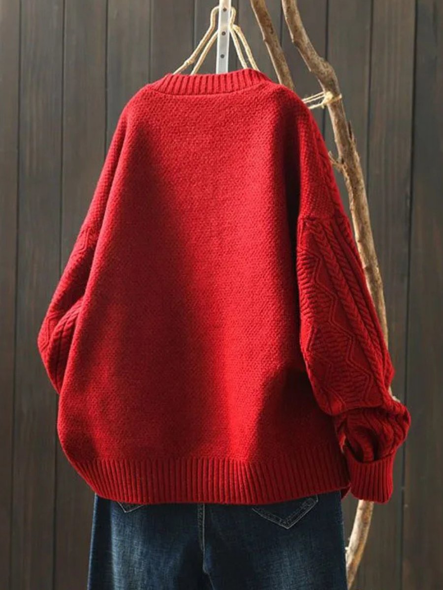 Women's oversized cable knit cardigan with a crew neck and button front