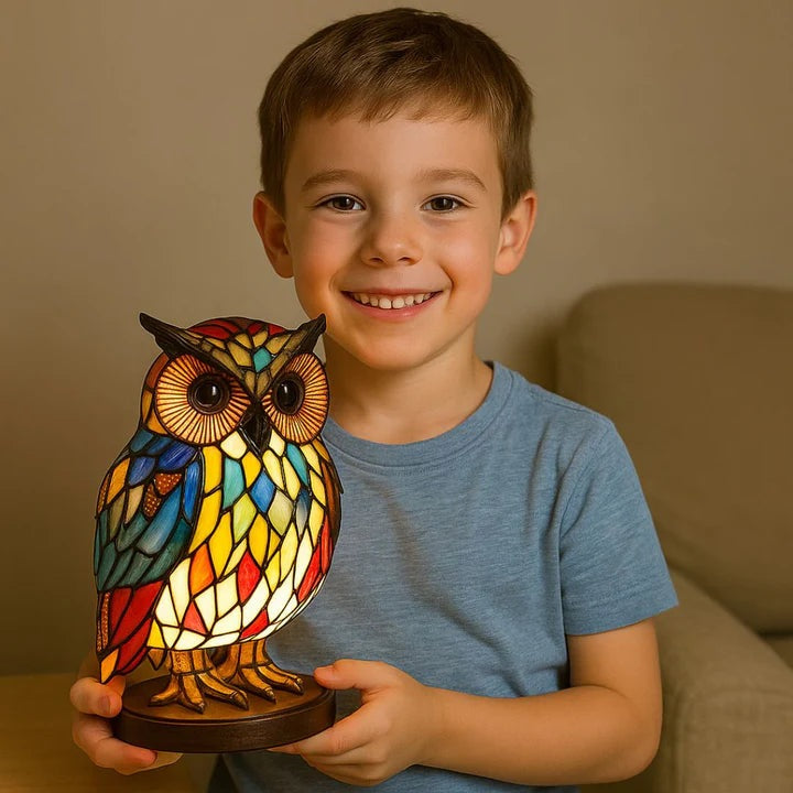 Owl lamp in a stained glass look with red, blue and yellow panels on a round base