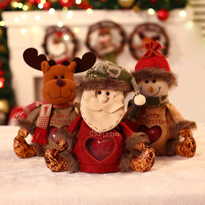 Seated plush Christmas figure with hat, scarf and a heart-shaped window in the body