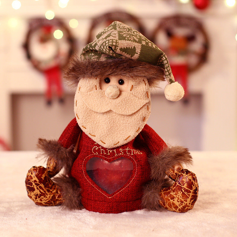 Seated plush Christmas figure with hat, scarf and a heart-shaped window in the body