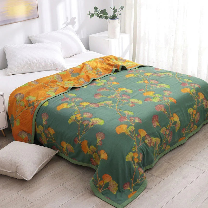 Quilted bedspread with a ginkgo leaf print on a made bed - without pillowcase