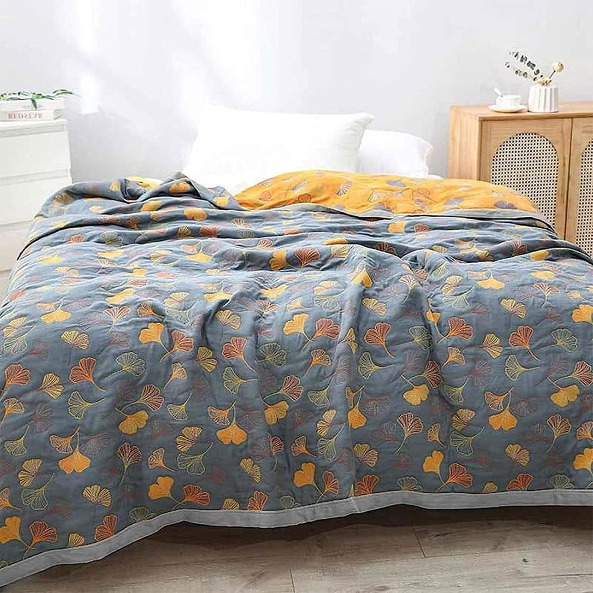 Reversible quilted bedspread with a ginkgo leaf print and wide binding