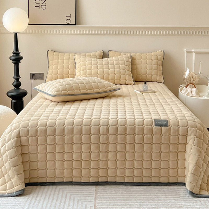 Quilted teddy bedspread with a square pattern on a double bed - sand