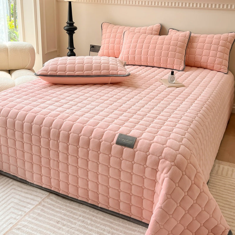 Quilted teddy bedspread with a square pattern on a double bed - pink