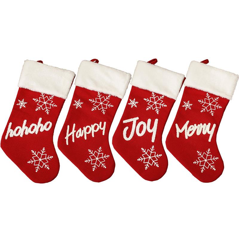 Red Christmas stocking with a white plush cuff, snowflakes and lettering