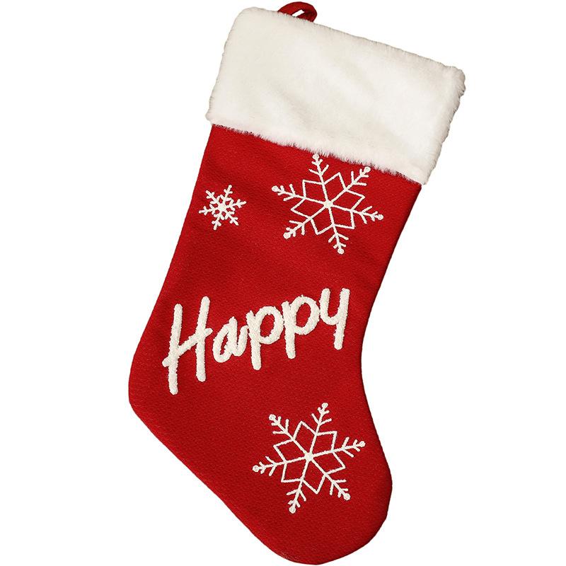 Red Christmas stocking with a white plush cuff, snowflakes and lettering - happy