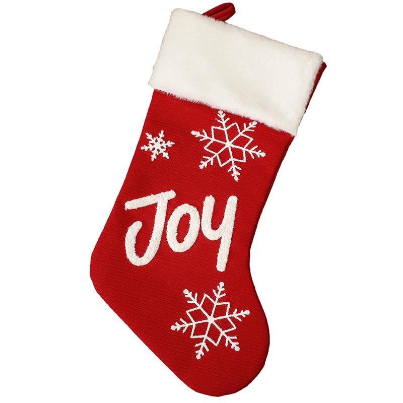 Red Christmas stocking with a white plush cuff, snowflakes and lettering - joy