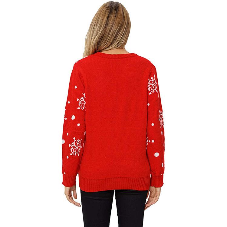 Women's red knitted Christmas jumper with a reindeer face and snowflake sleeves