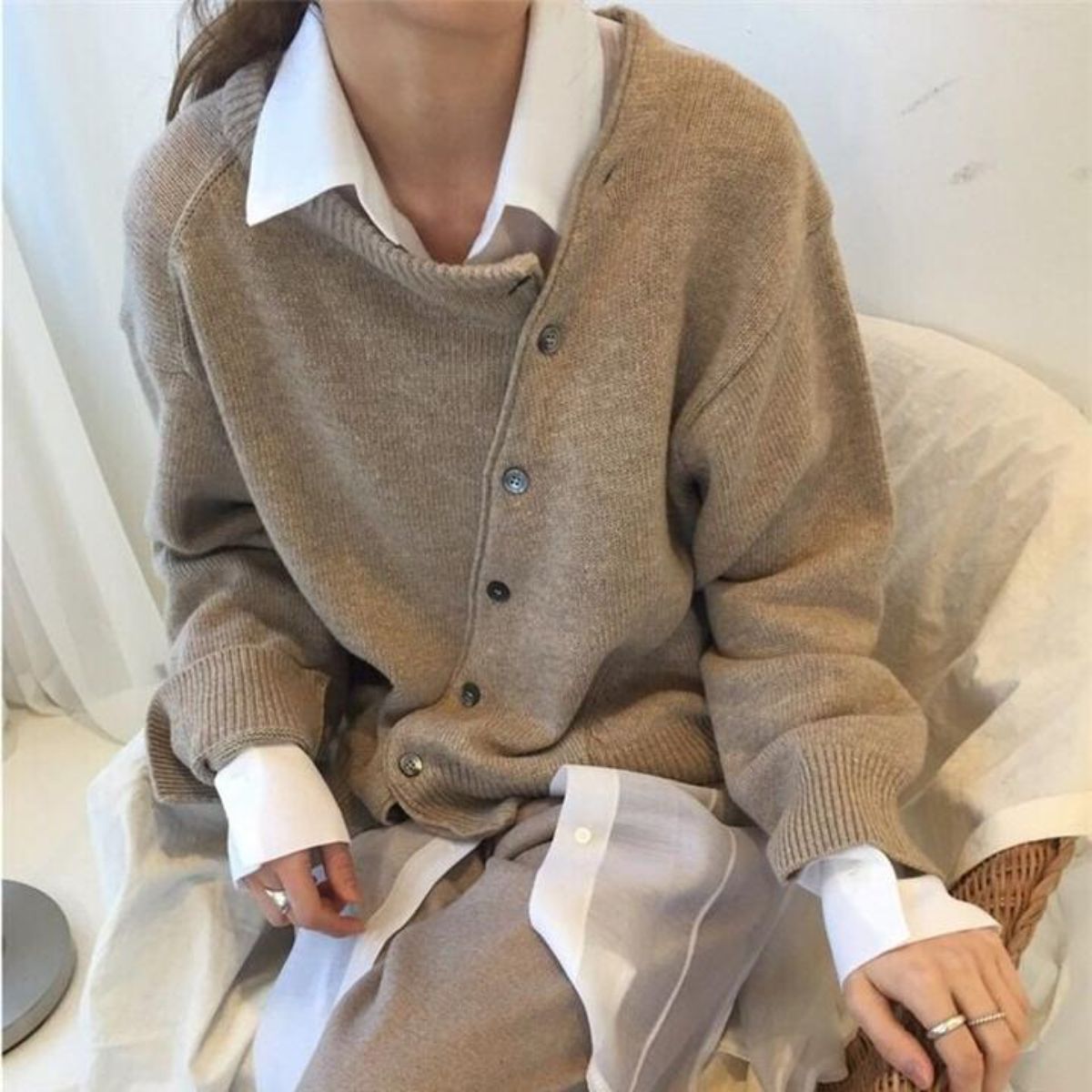 Women's relaxed knit cardigan with a round neck and asymmetric button front