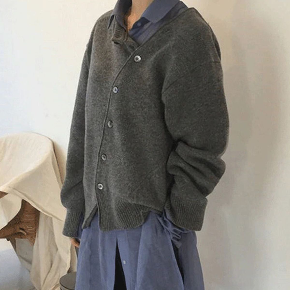Women's relaxed knit cardigan with a round neck and asymmetric button front