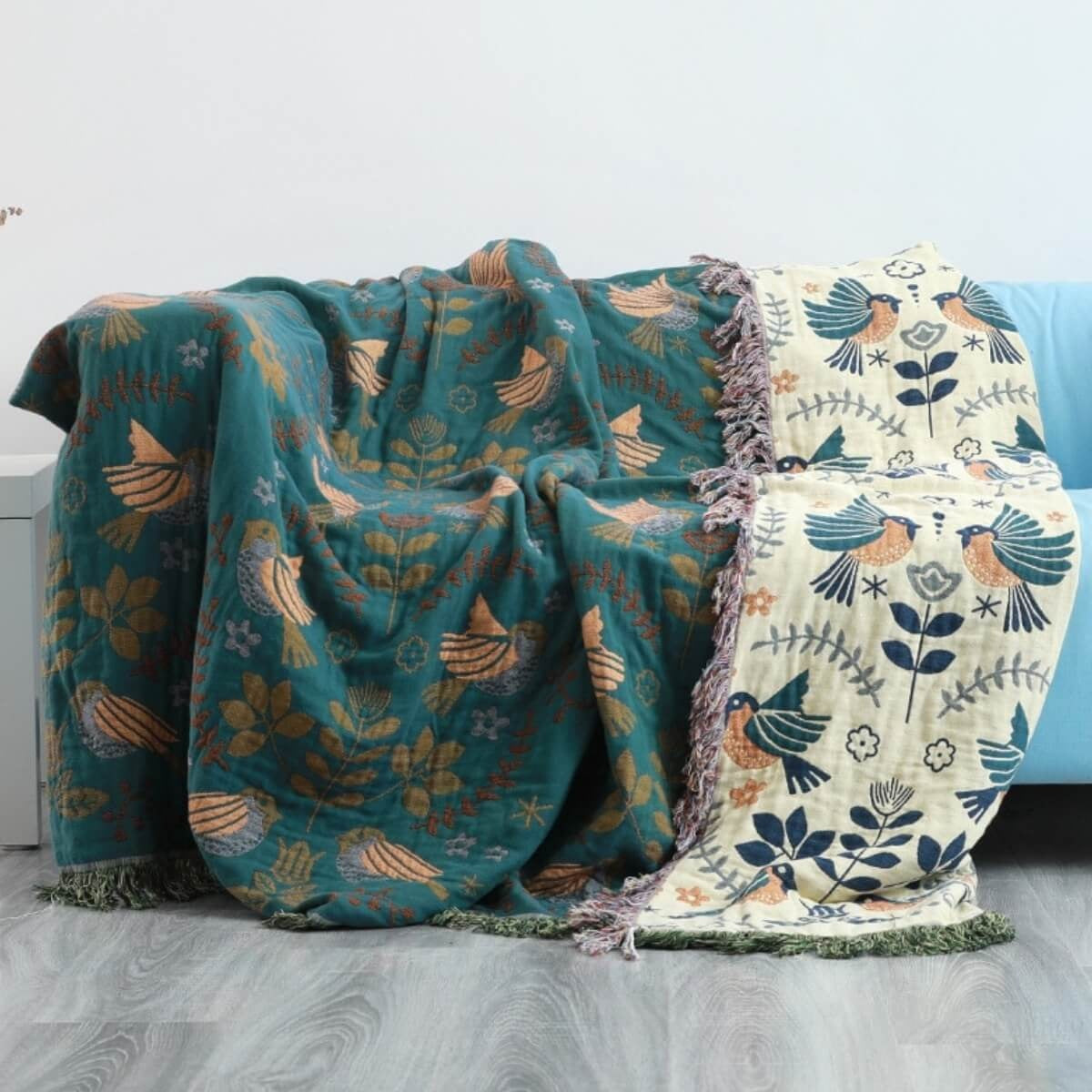 Reversible cotton throw with a bird pattern and tassels over a sofa - 230 x 250 cm