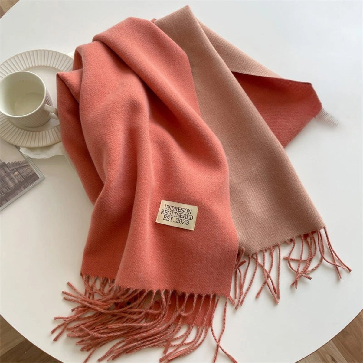 Women's reversible two-tone scarf with fringe and a small fabric label - coral