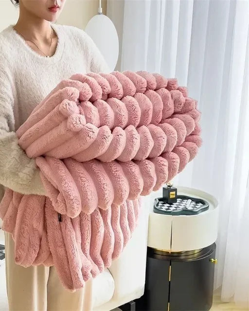 Ribbed faux fur blanket over a sofa - pink