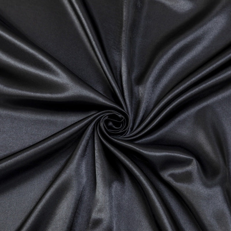 Satin sheet set with fitted sheet, flat sheet and two pillowcases on a bed - view 3