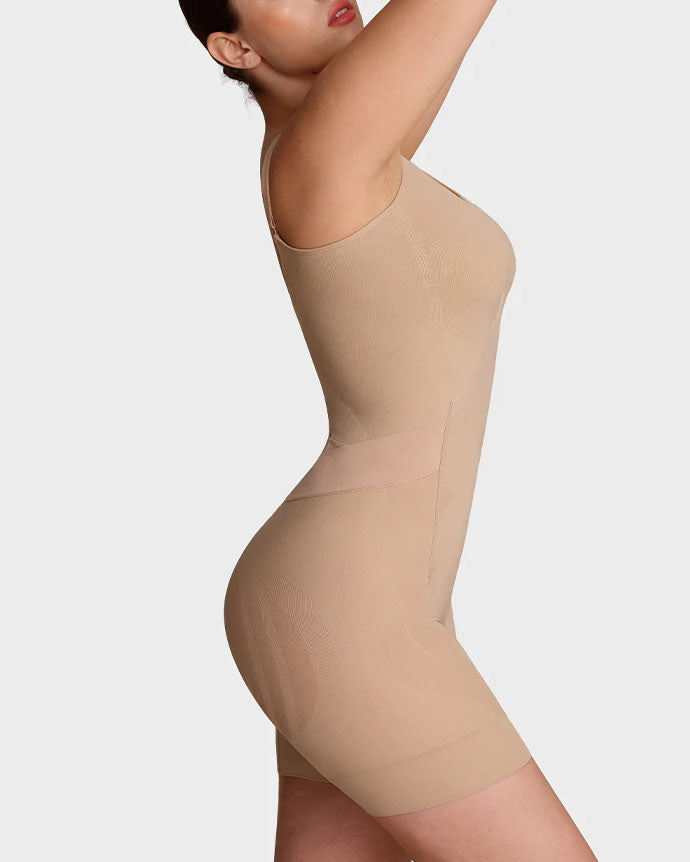 Seamless shapewear bodysuit with thin adjustable straps and legs to mid-thigh