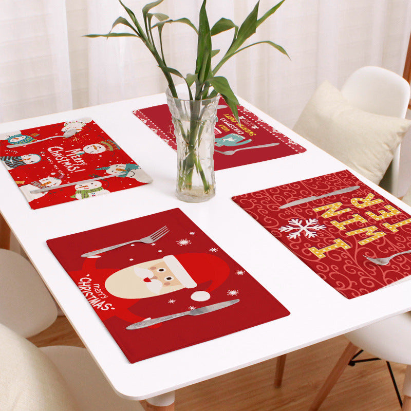 Set of four Christmas placemats with a festive print on a laid table