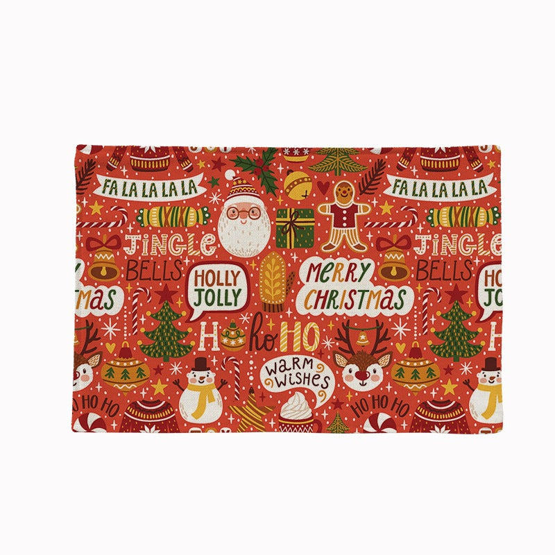 Set of four Christmas placemats with a festive print on a laid table - festive words on red