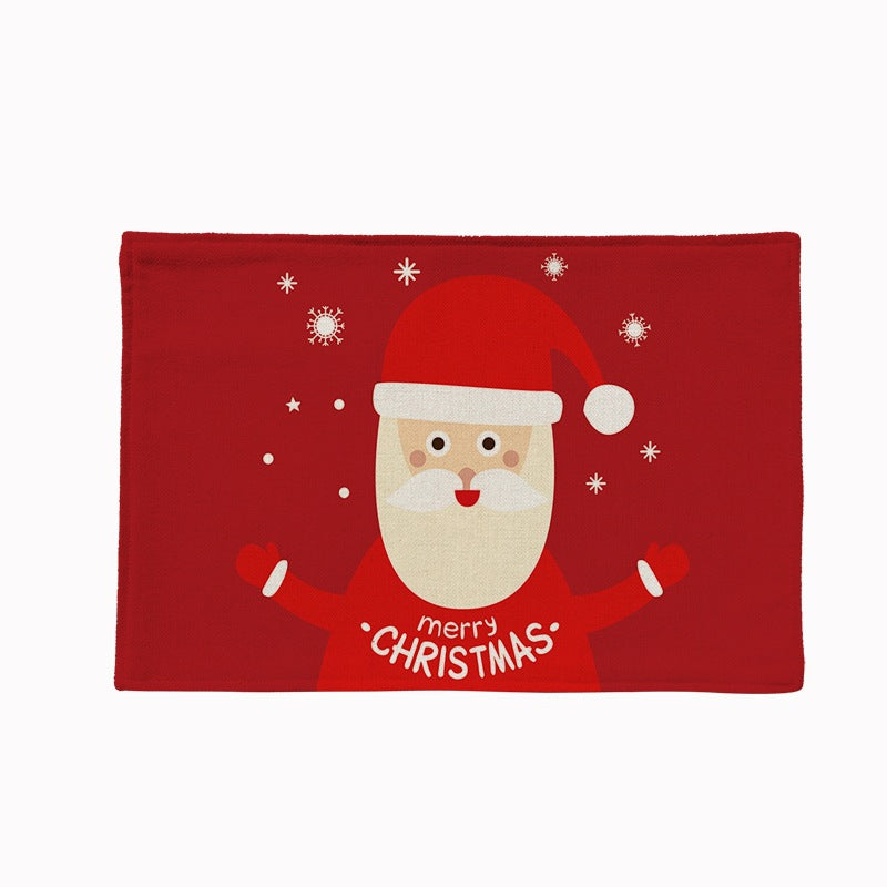Set of four Christmas placemats with a festive print on a laid table - father christmas on red