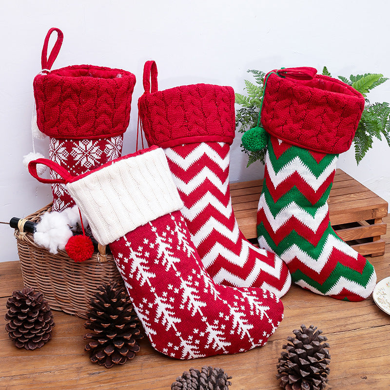 Set of four knitted Christmas stockings with cable cuffs, pompoms and Nordic patterns