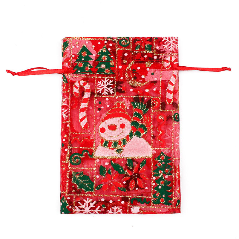 Sheer organza Christmas gift bags with red ribbon ties and festive print
