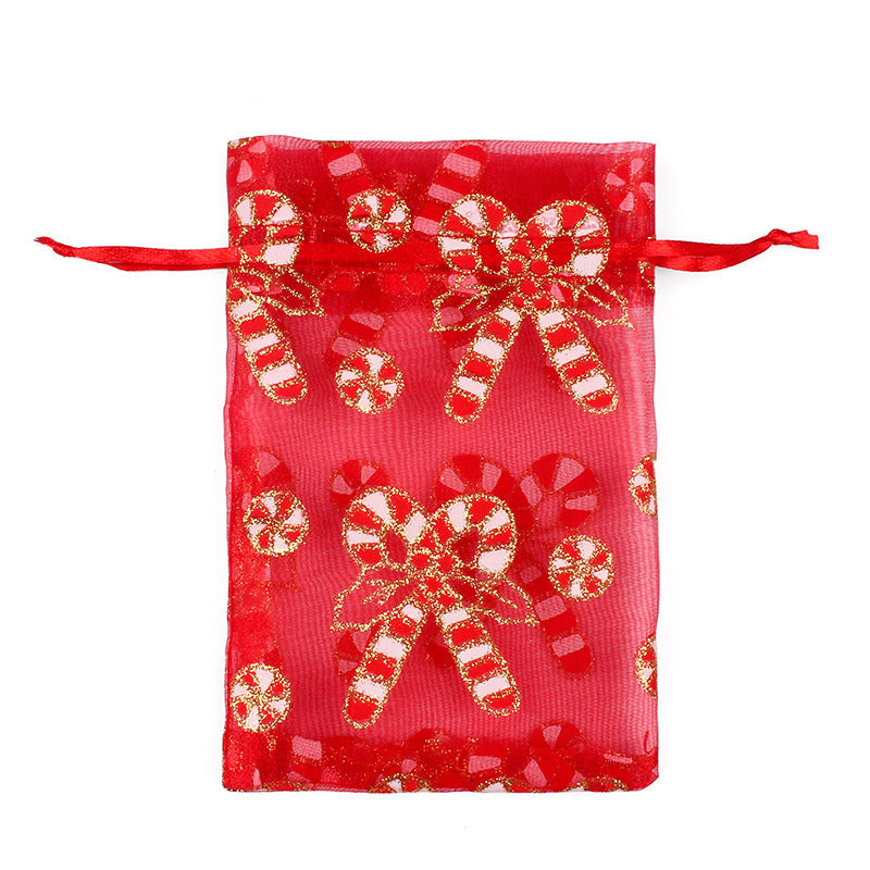 Sheer organza Christmas gift bags with red ribbon ties and festive print