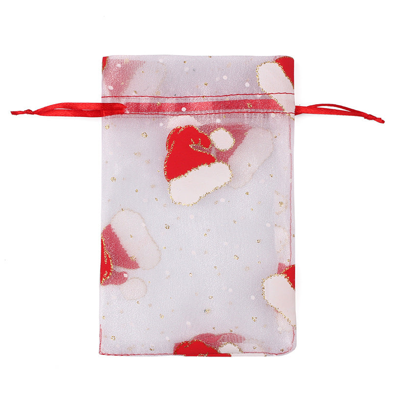 Sheer organza Christmas gift bags with red ribbon ties and festive print