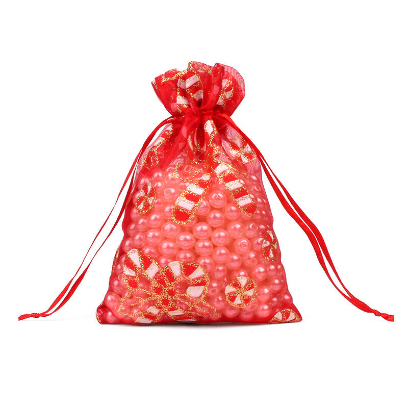 Sheer organza Christmas gift bags with red ribbon ties and festive print